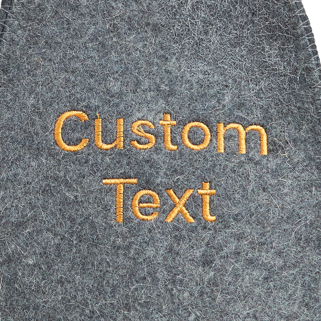 Close-up of custom embroidered text on gray wool felt sauna hat
