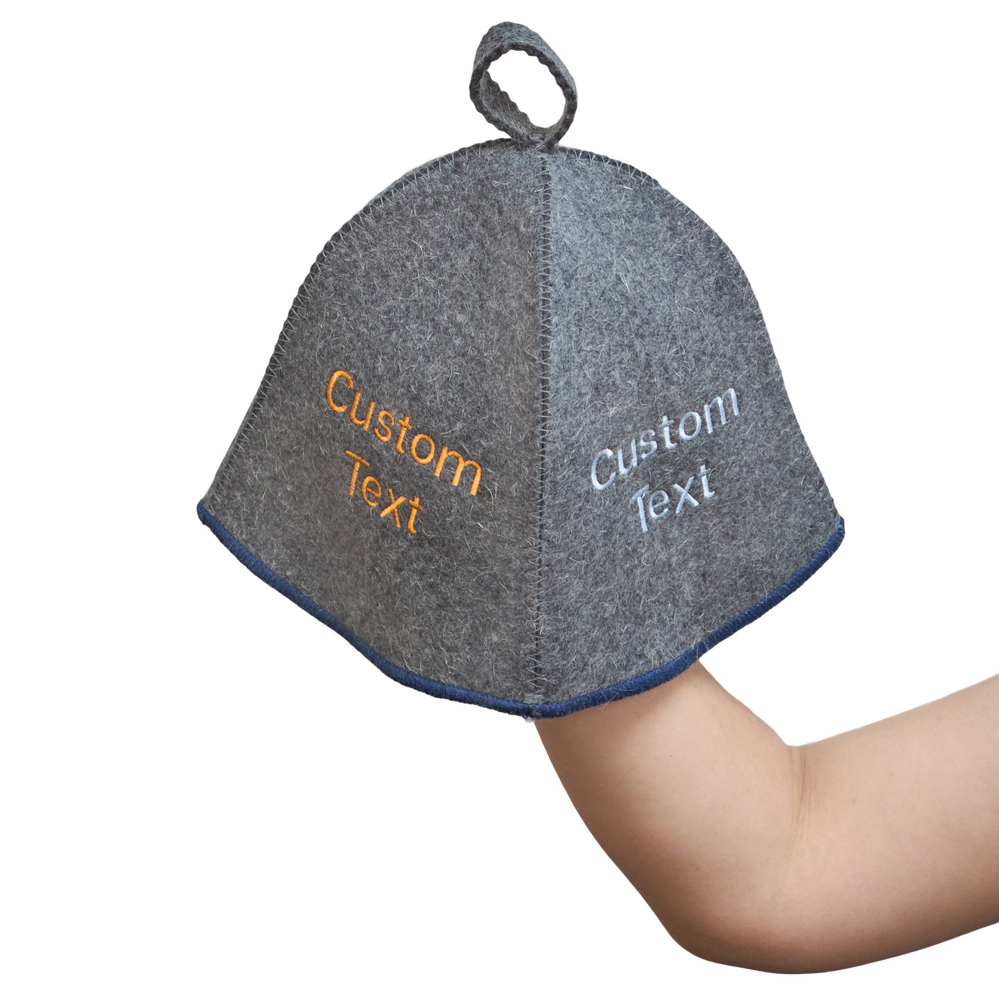 Gray wool sauna hat with blue trim and custom embroidered text, held in hand to show size and shape