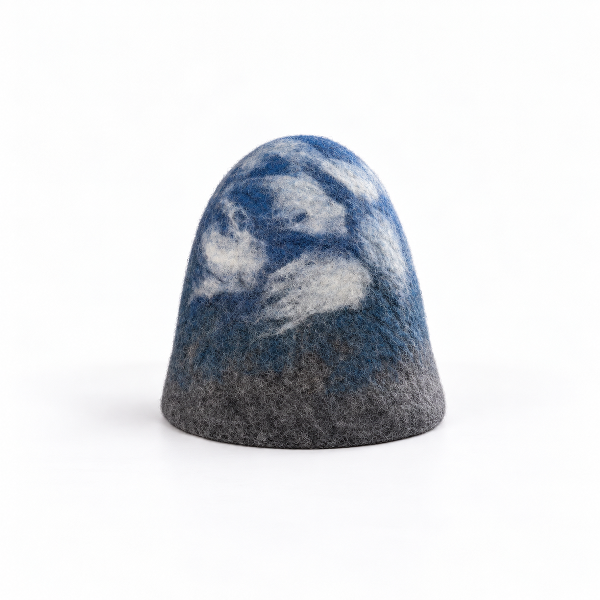 Hand-felted 100% wool sauna hat with a blue, gray and white mountain and cloudy sky design on a white background