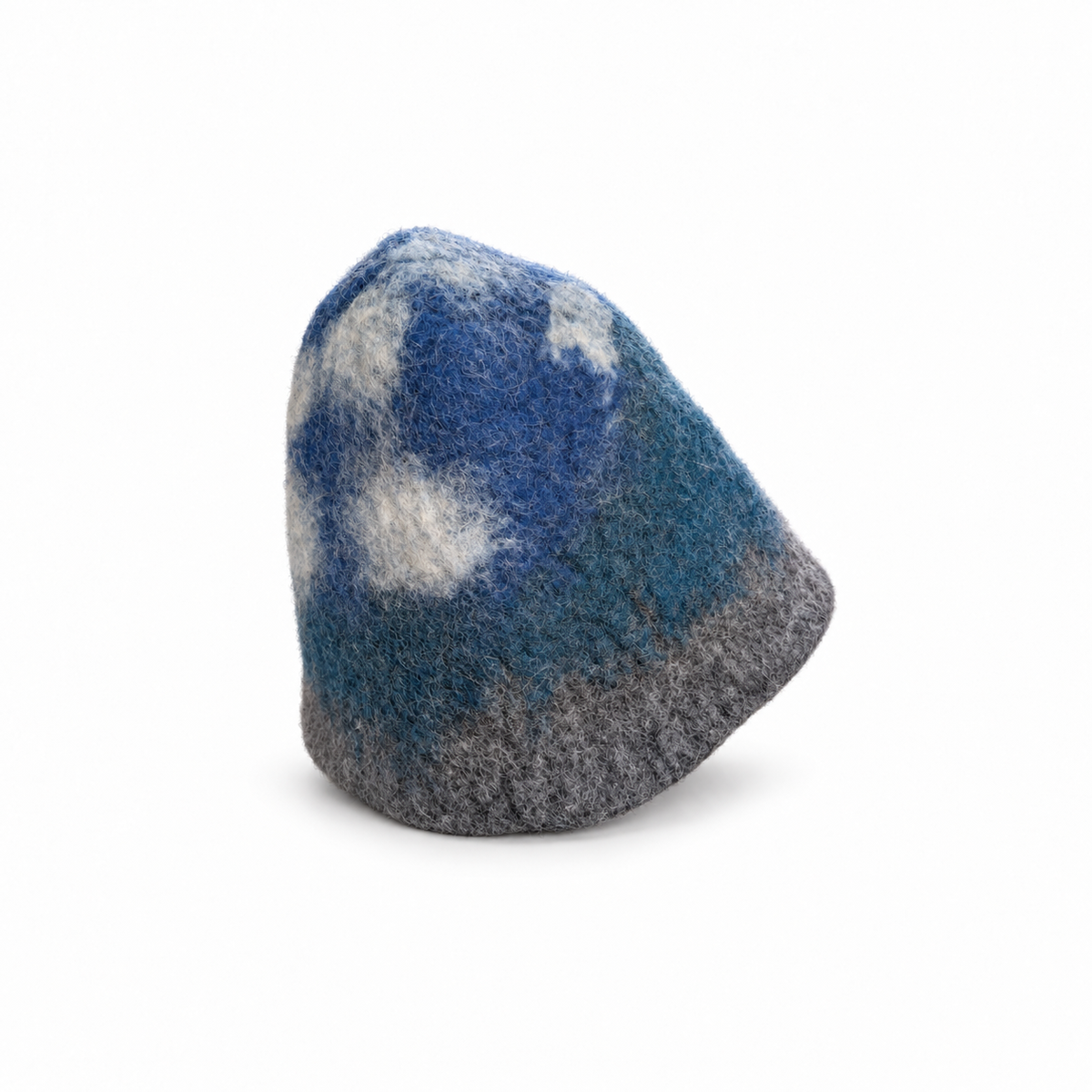 Hand-felted 100% wool sauna hat with a blue, gray and white mountain and cloudy sky design, shown from the back at an angle on a white background