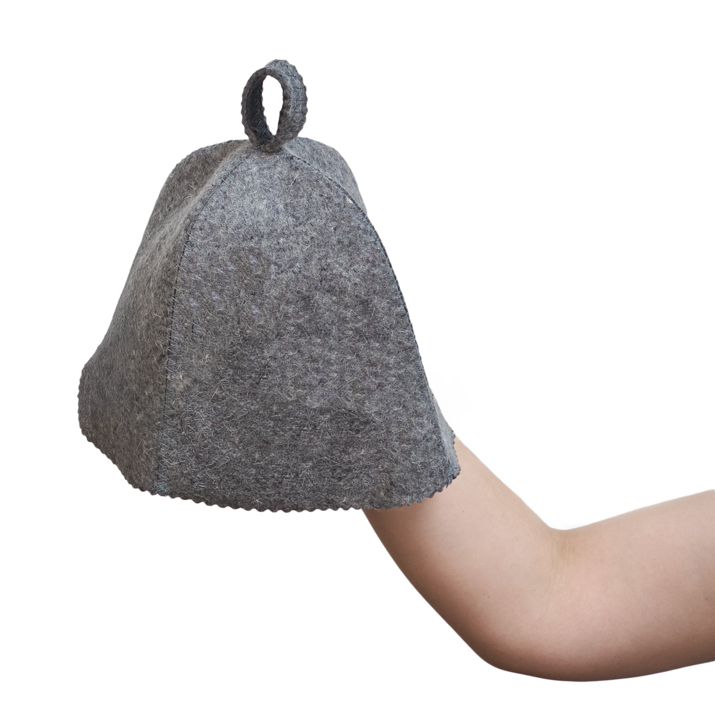 Gray felted woolen sauna hat held by a hand on a white background
