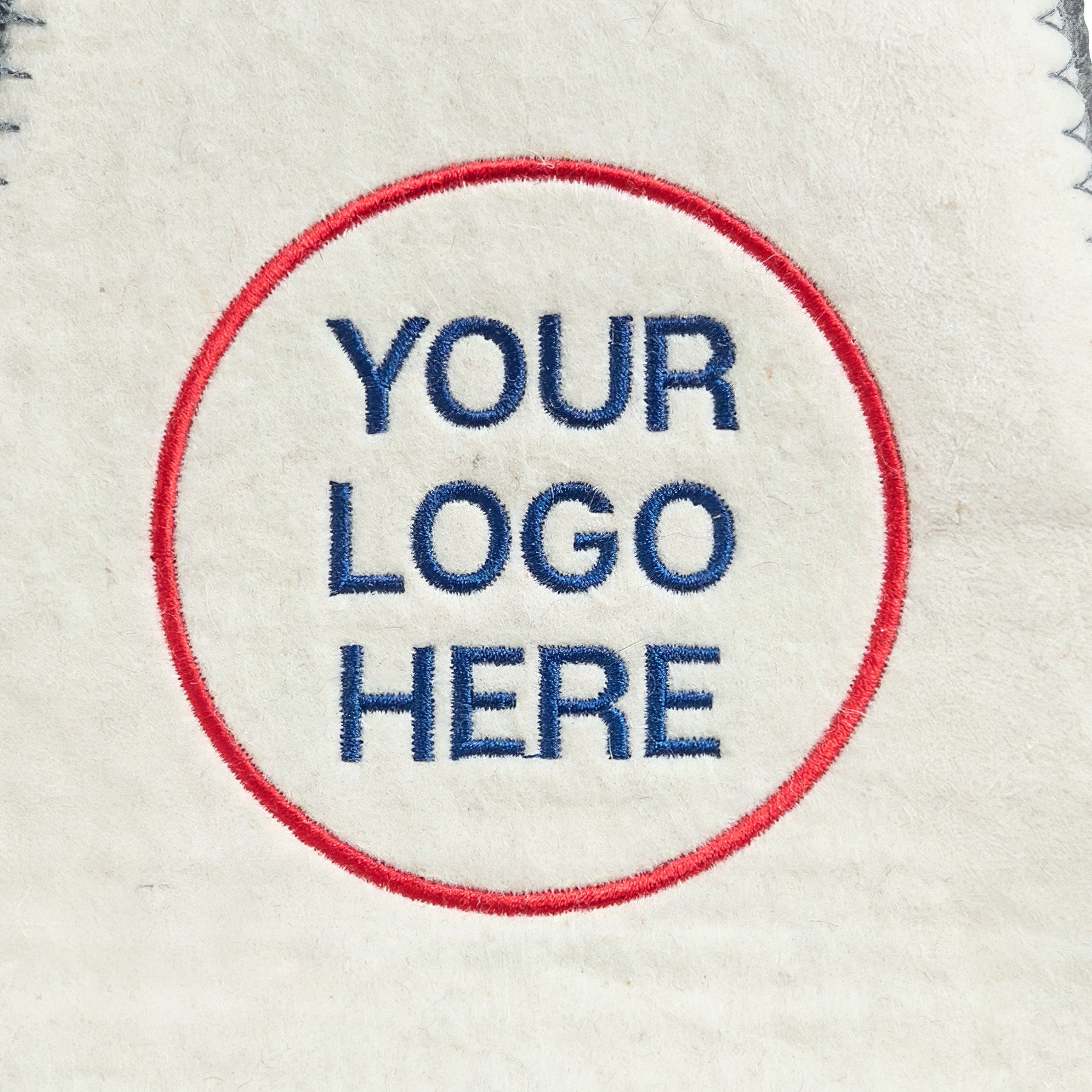 Close-up of custom embroidered logo on white felt sauna hat