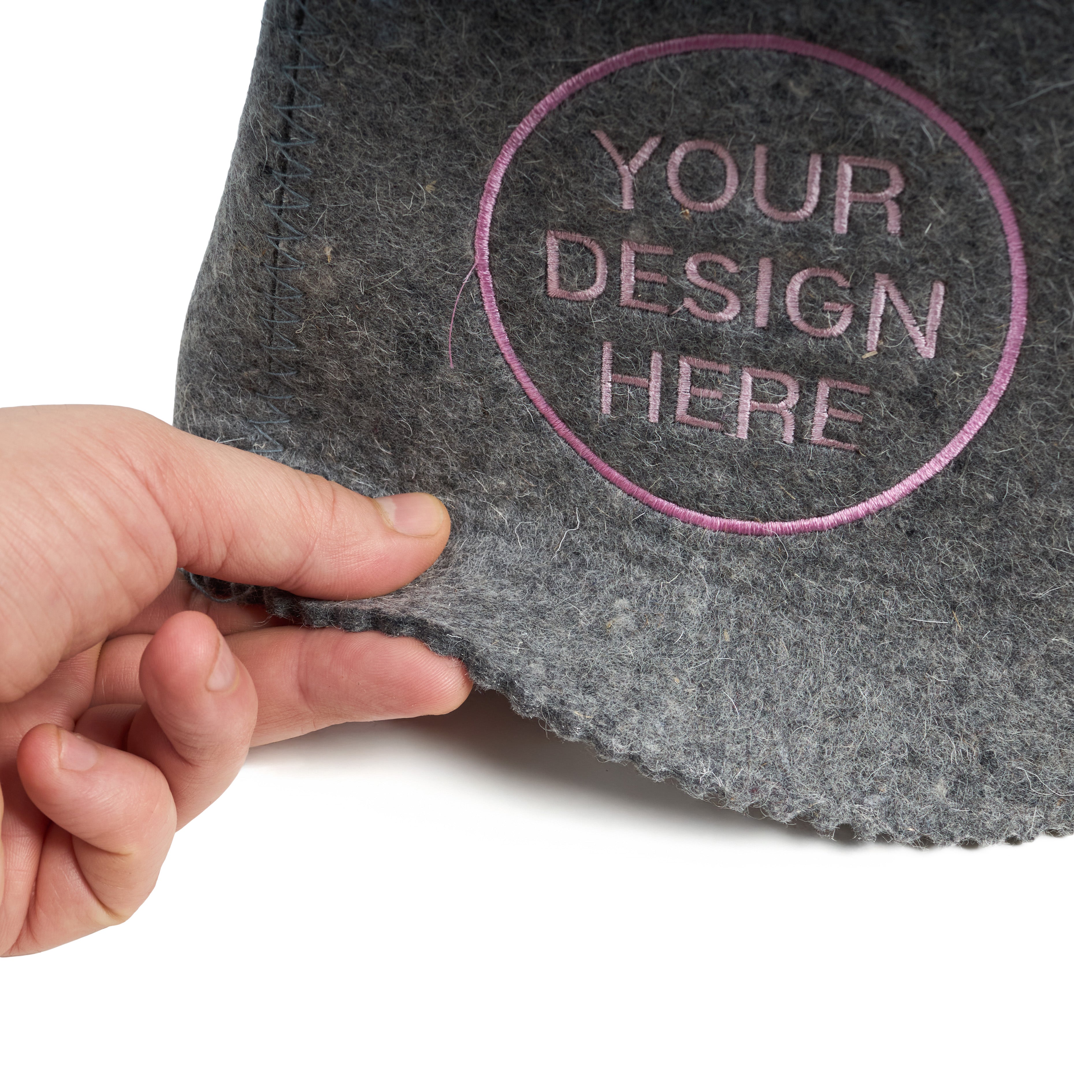 Gray felt with 'Your Design Here' text and a hand holding it on a white background