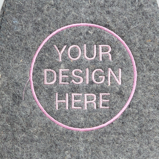 Close-up of pink embroidered custom design on gray wool sauna hat