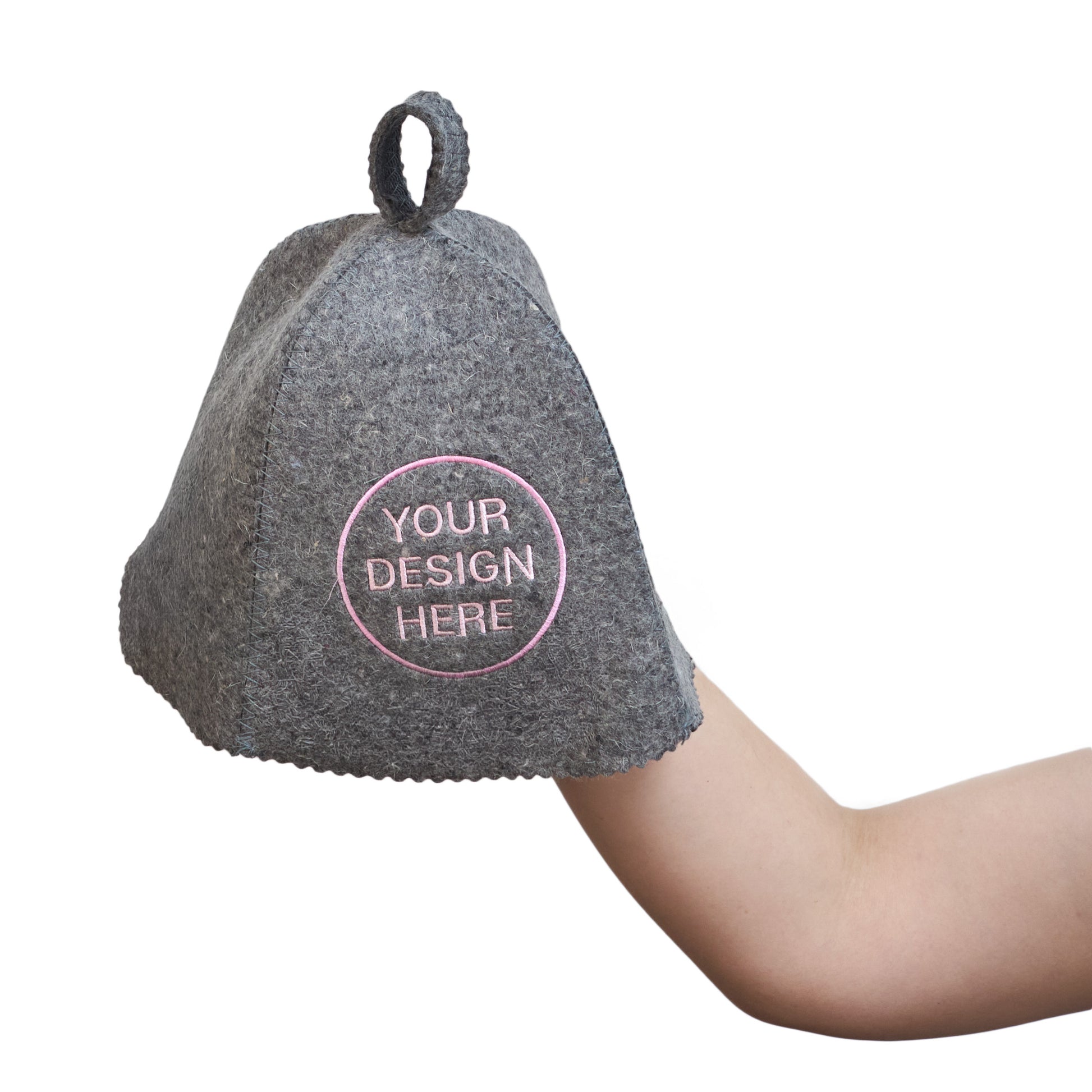 Gray wool sauna hat with custom embroidered design held in hand