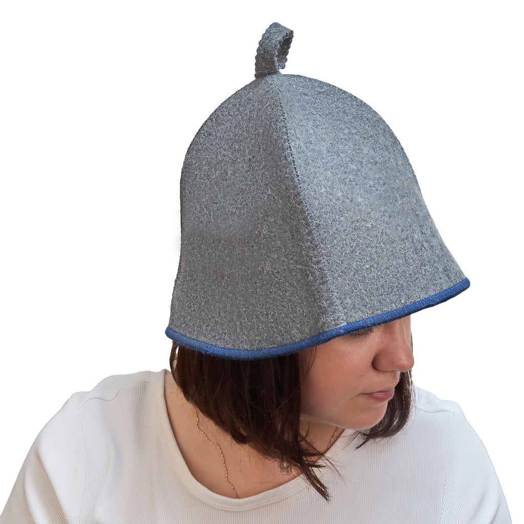 Gray wool sauna hat with blue trim, worn on a model to show fit and coverage