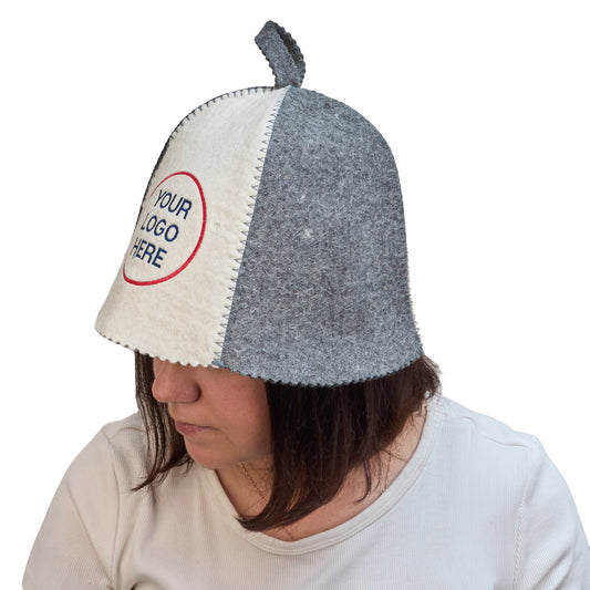 Two-tone wool sauna hat in white and gray with custom logo embroidery, worn on a model to show fit